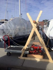 Removing the old Westerbeke 21 from the boat in the water